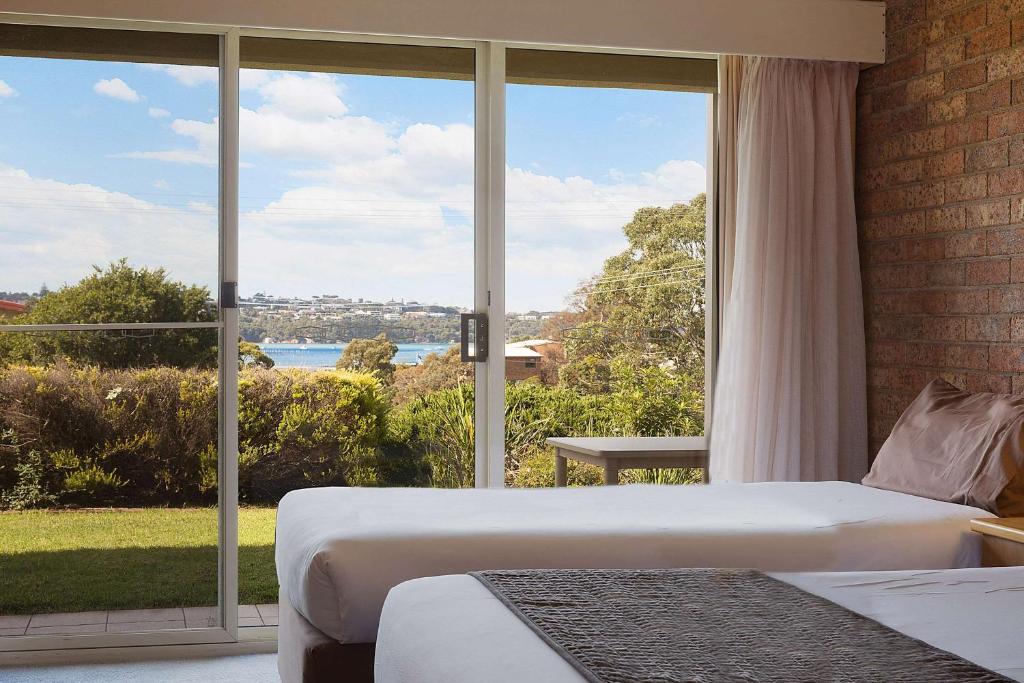 Family room with two beds and a large lake-view window
